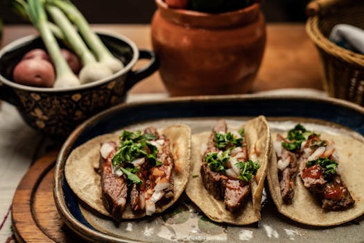 How Is Mexico's Economy Handling Trump 2.0 So Far? 3 Steak tacos topped with cilantro and onions on a rustic table setting.